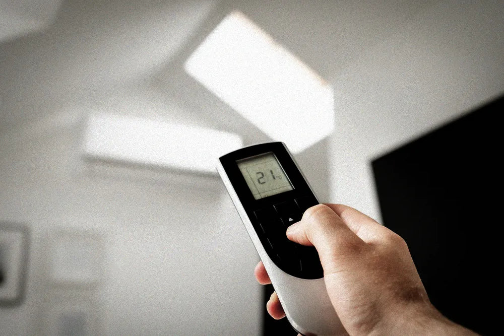 HVAC technician checking refrigerant pressure during an AC recharge