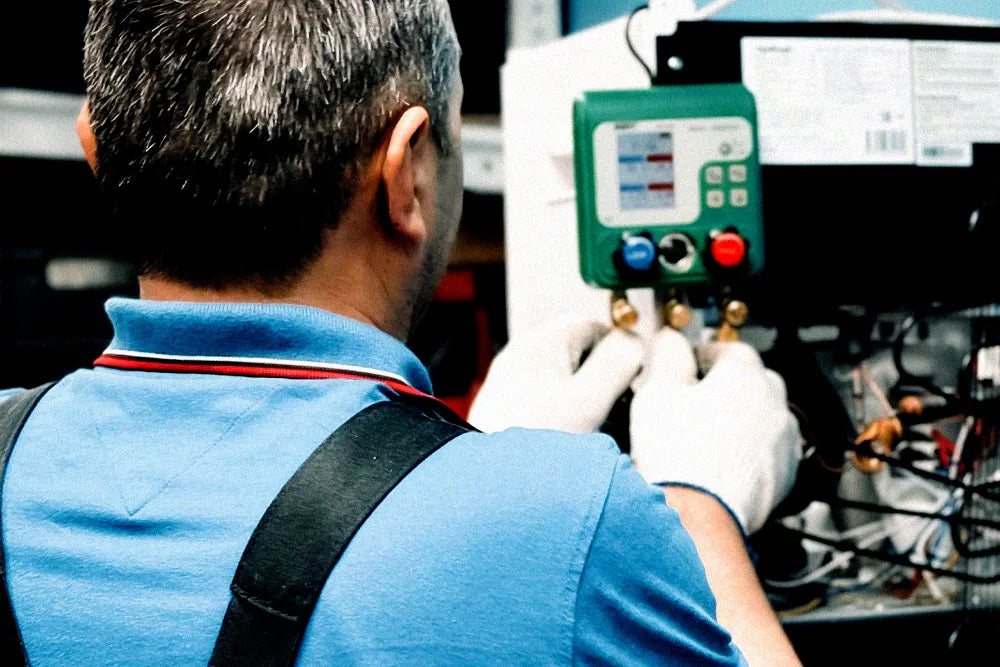 HVAC technician diagnosing an air-conditioning system after a refrigerant recharge