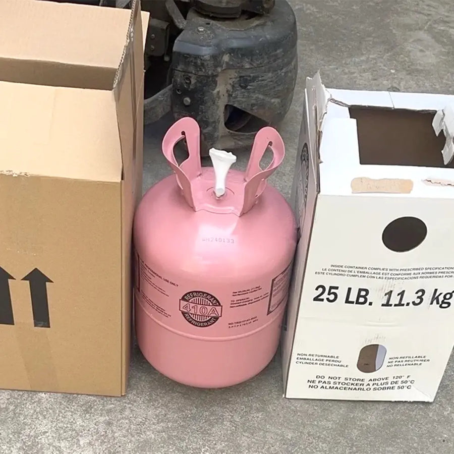 Pink R410A refrigerant cylinder next to 25 lb shipping box